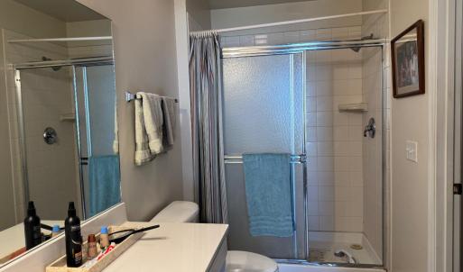 Ensuite Bedroom 1 bathroom with walk-in closet and linen closet