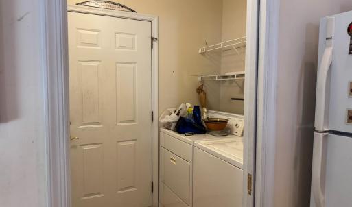 The laundry area door leads to the garage. Just outside the door is a utility laundry sink. Washer and dryer convey.