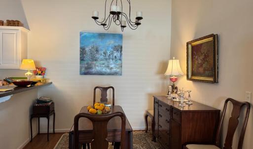 The formal Dining Room area is behind the Greatroom sitting area and to the side of the kitchen island.