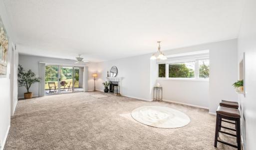 Open concept with lake and mountain views through double patio doors.