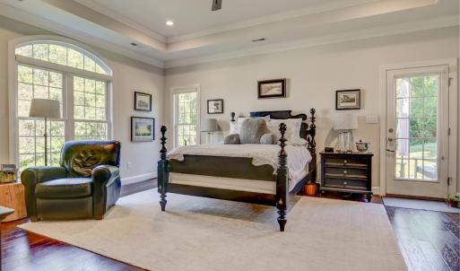 Primary Bedroom - Large and spacious - with vaulted ceilings, ceiling fan and recessed lighting.  Exterior door to back patio