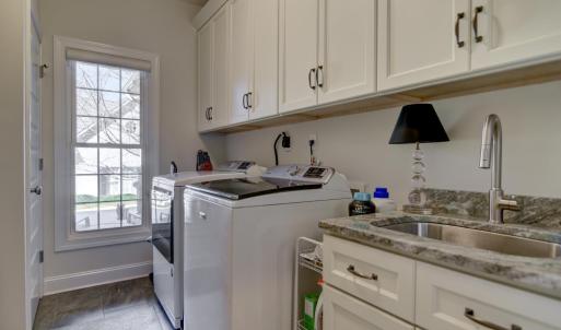 Separate Main Level Laundry Room - Washer/Dryer hook ups, oversized sink and lots of cabinets