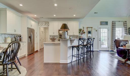 View from Hallway, into the Great Room, Kitchen/Bar and Seating area within the Kitchen.