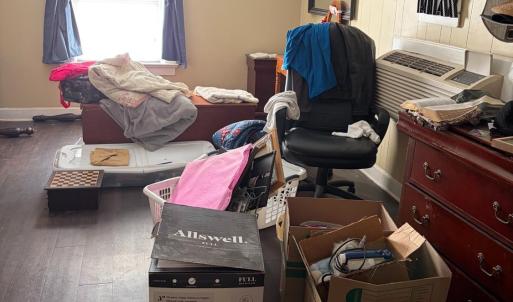 large bedroom. owner is storying some boxes for a relative