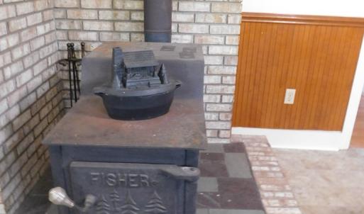 Fisher wood stove in kitchen area to convey