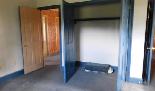 Bedroom 4 showing large closet and other doors lea