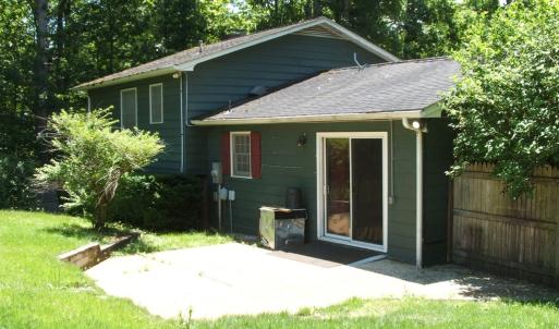 Rear view showing sliding glass doors leading into kitchen