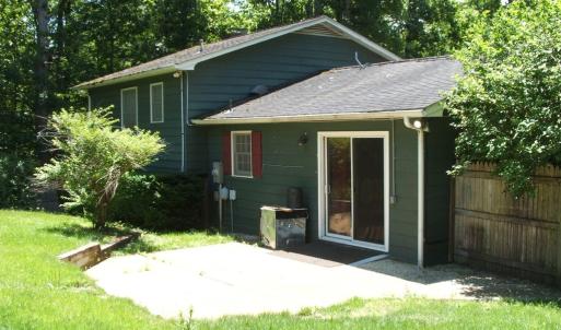 Rear view showing sliding glass doors leading into kitchen