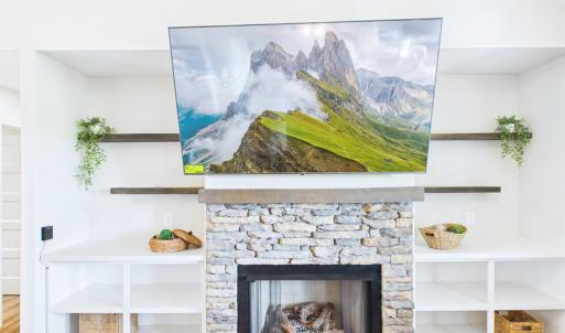 Fireplace / Built-Ins, Stone Fireplace with Custom Built-In Shelving creates a warm focal point for the Open Living Area.