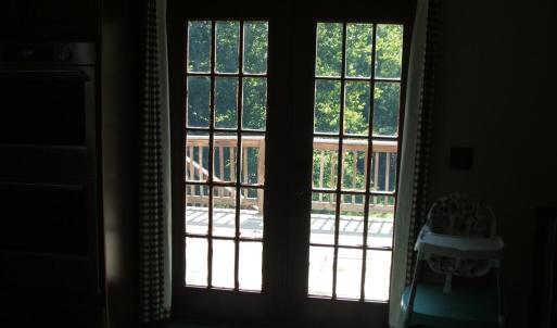 French doors lead from kitchen/dining area to deck