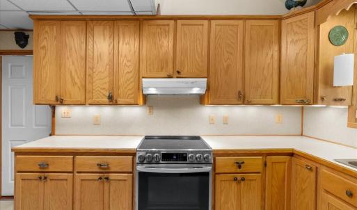 Primary Kitchen - Main Floor, Oak cabinets provide ample storage.