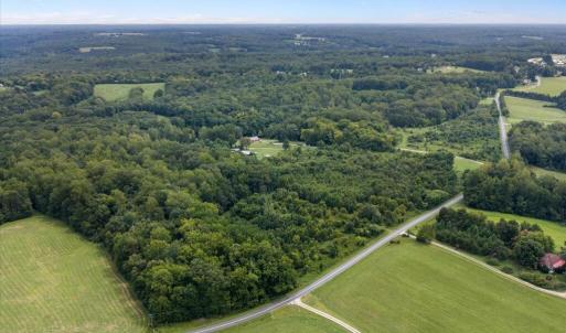 Aerial looking NE - VA-619 in foreground, Home is central in image, nestled into 100+ acres.
