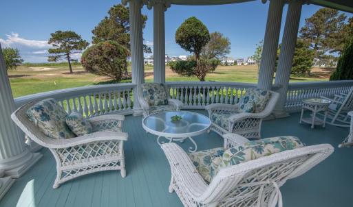 Back porch overlooking bay and golf course
