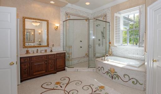 Impressive owner suite bath with mosaic design