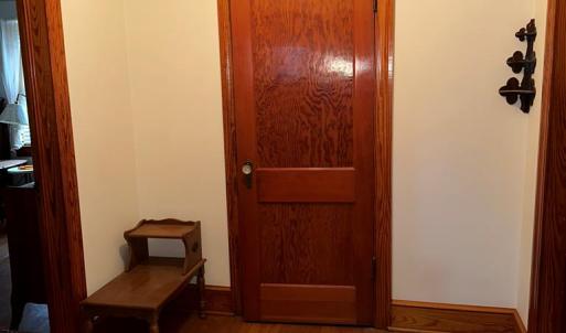 Hallway to bedrooms, bath, and attic stairs