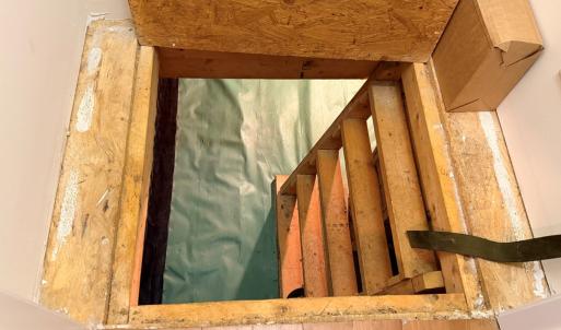 Closet access to the crawlspace.  Crawlspace has vapor barrier