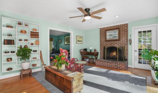 Den with wood burning fireplace