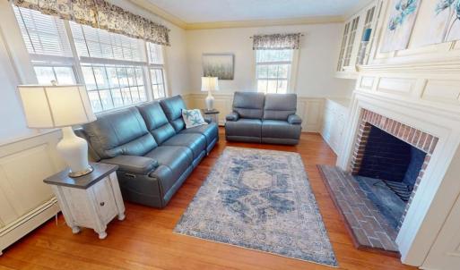 Formal living room with wood burning fireplace.