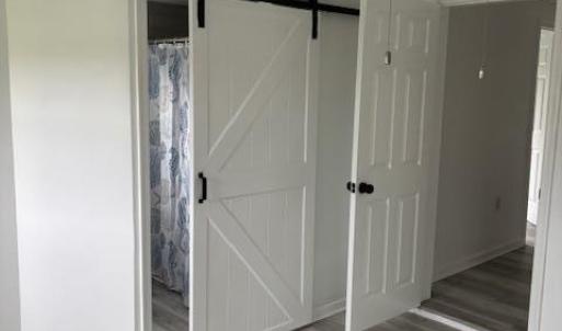Interior barn doors on owner's bathroom