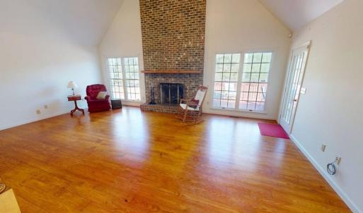 Family room with fireplace and wood floors.