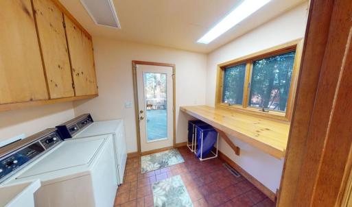 laundry/mud room with access to rear deck