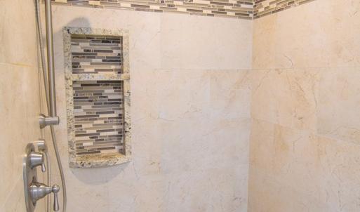 Tiled walkin shower in primary bedroom