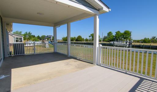 Covered porch and deck overlooking water