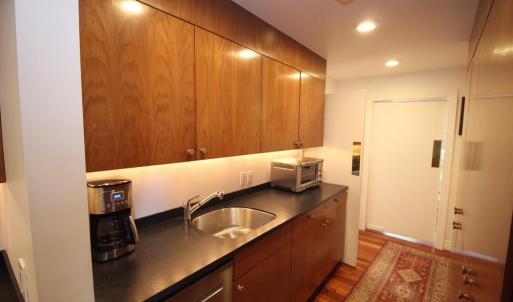 Butlers pantry, Opposite the sink in a solid wall of cabinets.