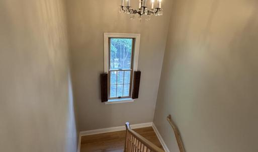 Stairs looking down with chandelier