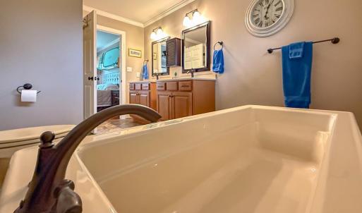Main Primary Bathroom, With sinking Tub as well as a shower.