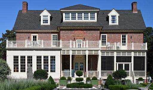 Waterfront/rear side of house, Left bottom library windows. Right side screed dining porch, and above each are observation decks off 2 of the bedrooms w/ additional center hall entrance