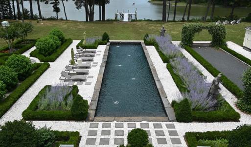 Gunite pool surrounded by gardens