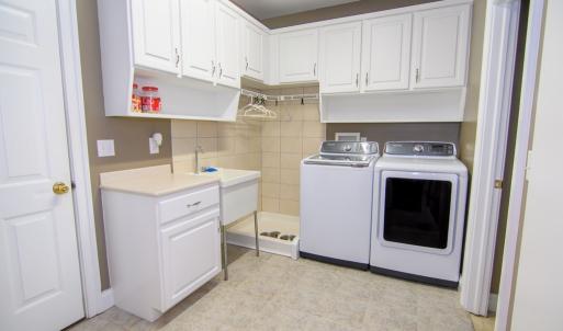 Laundry Room, Plenty of Storage, Folding Area, Drying Area. Door to the right leads to large storage closet.  The door to the left leads to the garage.