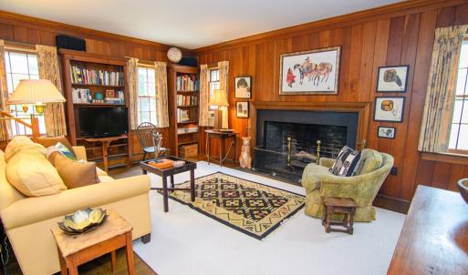 Den, Features include Fireplace and the staircase in the corner leads to one of two attic spaces.
