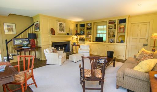 Library, Features include Fireplace, Built in cabinetry, Hidden closet, The doorway to the right leads out to the porch.