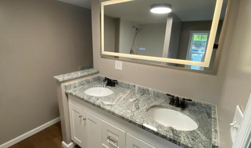led mirror over granite topped vanity