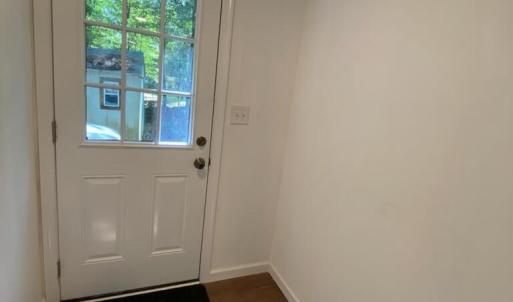 Back door from parking area and shed access area that keeps mud and dirt in the laundry room area