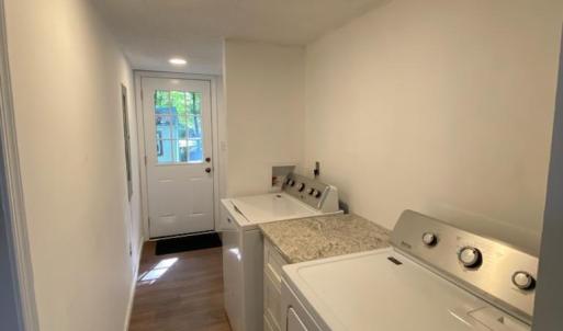 nice laundry room, New Maytag washer and dryer with a new water heater tucked away in a closet offers a little more storage space.
