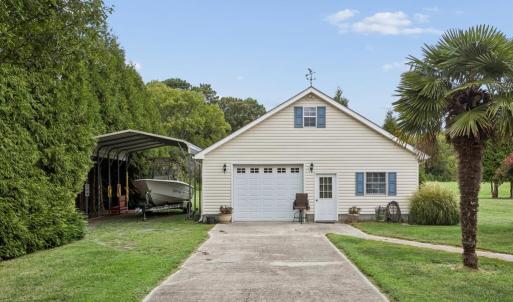 Detached garage with finished office space, workshop, and large back room with a sink
