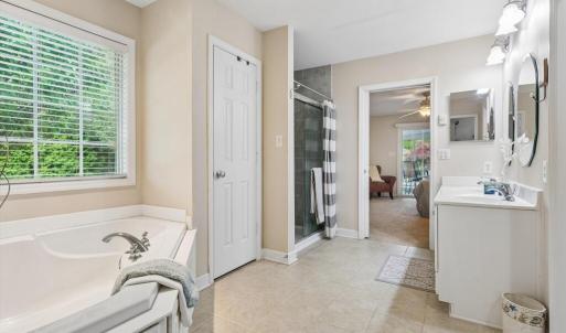 Primary Bathroom w/dual sinks, walk-in tile shower, and large soaking tub.