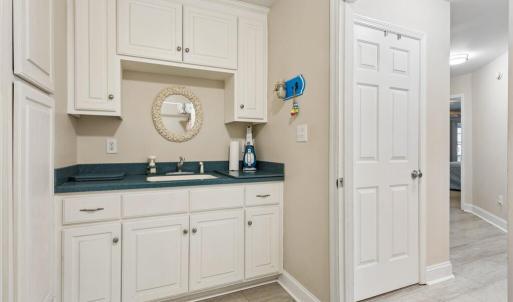 Utility room w/sink, laundry and entrance to 2 car attached garage