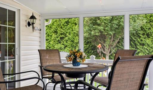 Screened Porch w/composite decking and sliding glass doors to the sunroom as well as the primary bedroom.