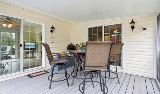 Screened Porch w/composite decking and sliding glass doors to the sunroom as well as the primary bedroom.