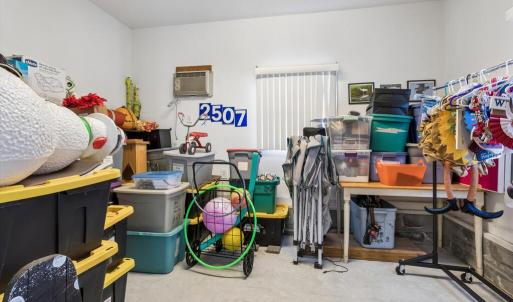 Detached garage office/store area, finished space with a wall air conditioner unit.