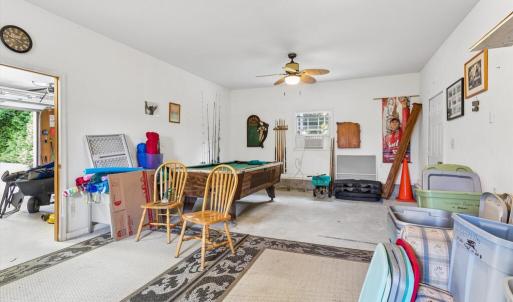 Large room in detached garage, behind the garage bay, plumbed with a sink.