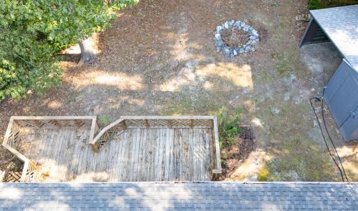 Aerial showing house, deck, fire pit and shed
