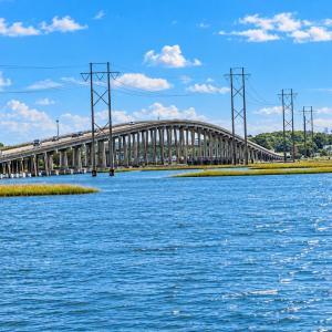 Arched Bridge Over Blue Marsh Waters