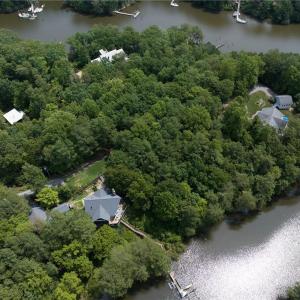 Birds eye view of property with a water view