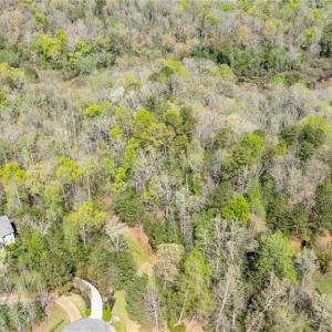 Aerial view of property from above cul de sac looking east