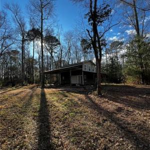 Two story barn with RV parking on the side.